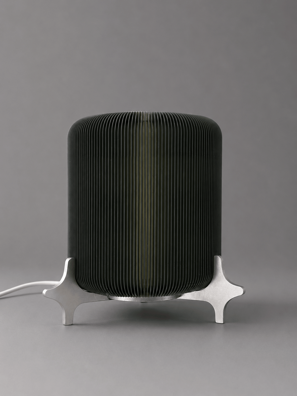 AERO designer table lamp by Natalia Design Co. featuring a ribbed translucent PETG diffuser and sculptural satin aluminium base in a minimalist industrial design.