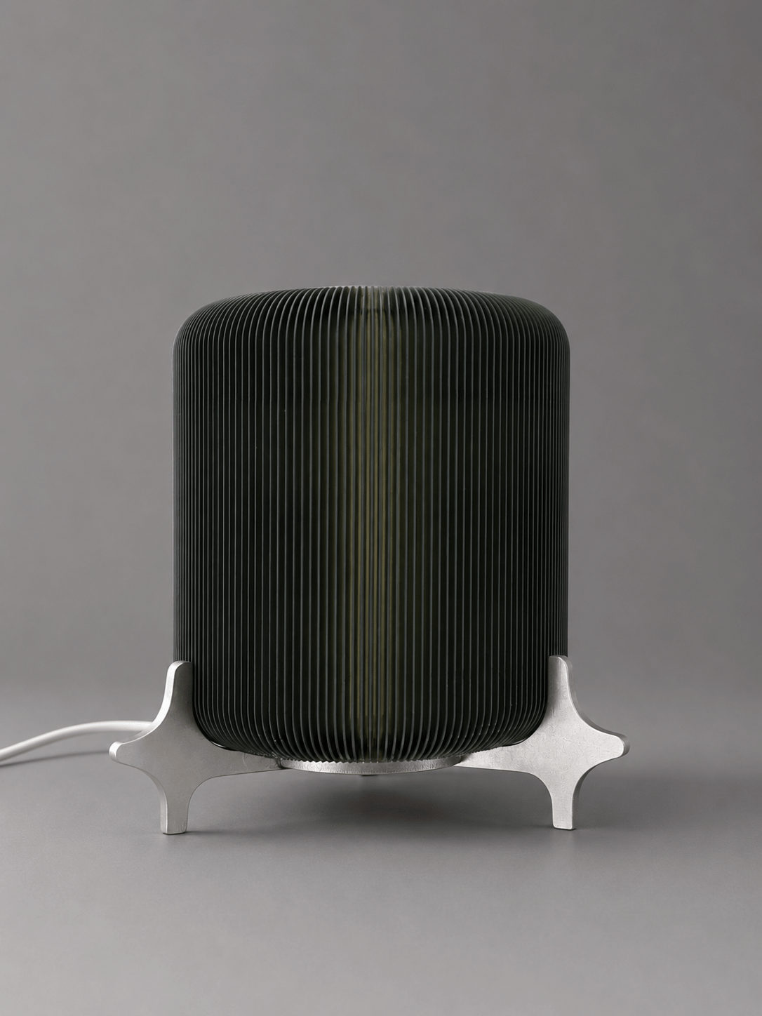 AERO designer table lamp by Natalia Design Co. featuring a ribbed translucent PETG diffuser and sculptural satin aluminium base in a minimalist industrial design.